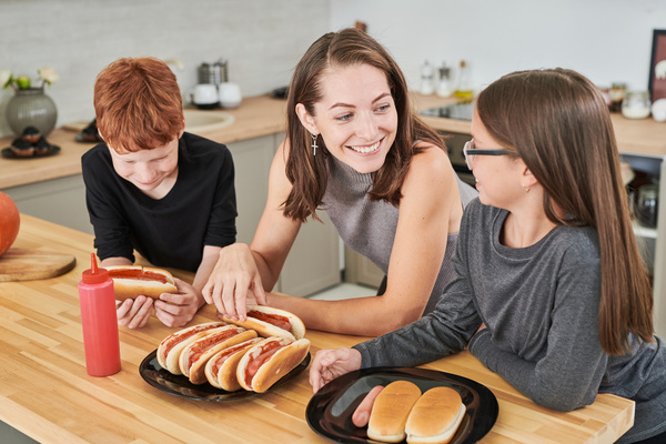 Woman Talks to Her Children and They Eat Hot Dogs